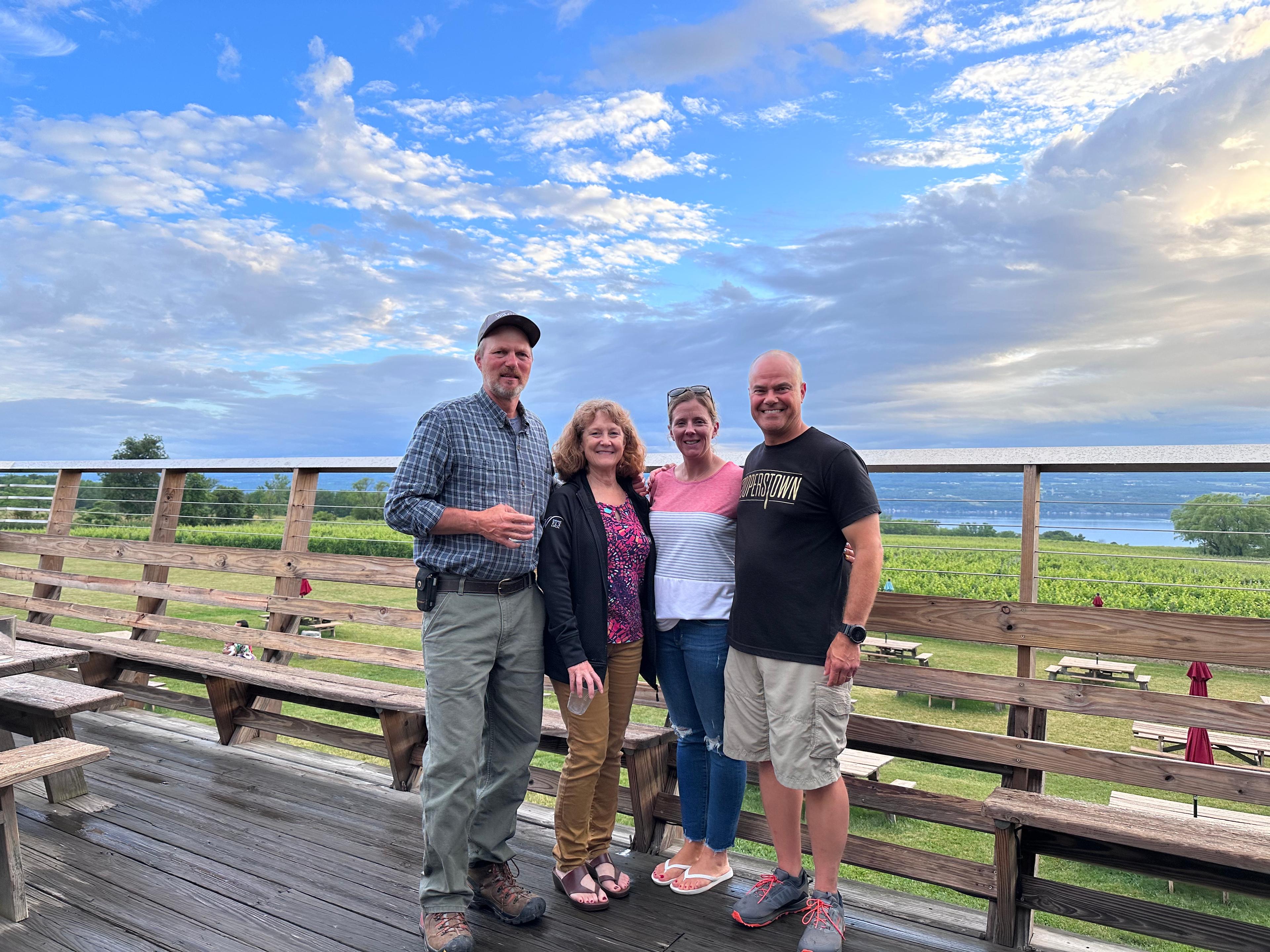 John and Debbie Wagner of Wagner Vineyards standing with Bill and Kristy Darcy
